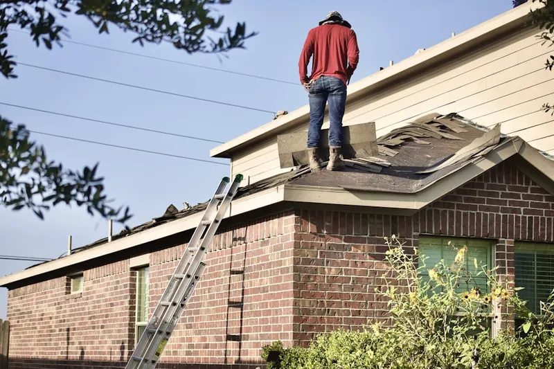 Professional roofer working on a residential roof in Lloyd